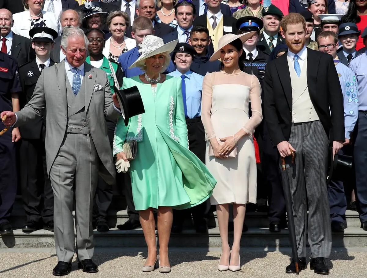 Prince Harry, King Charles, Queen Camilla, Meghan Markle and other guests pose for a photograph during party at Buckingham Palace