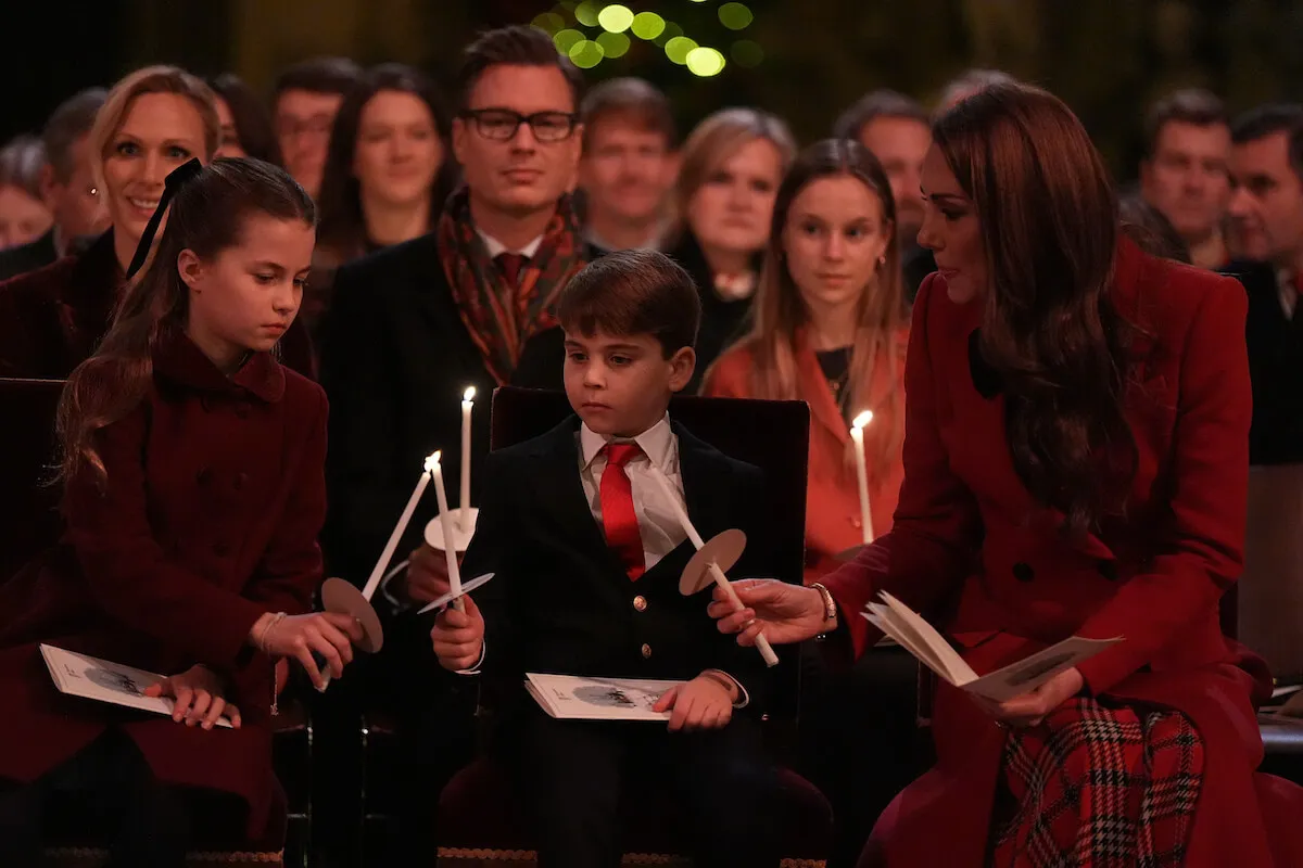 Prince Louis, who kept the ballet performance at Kate Middleton's carol concert a secret, sits with Princess Charlotte and Kate Middleton