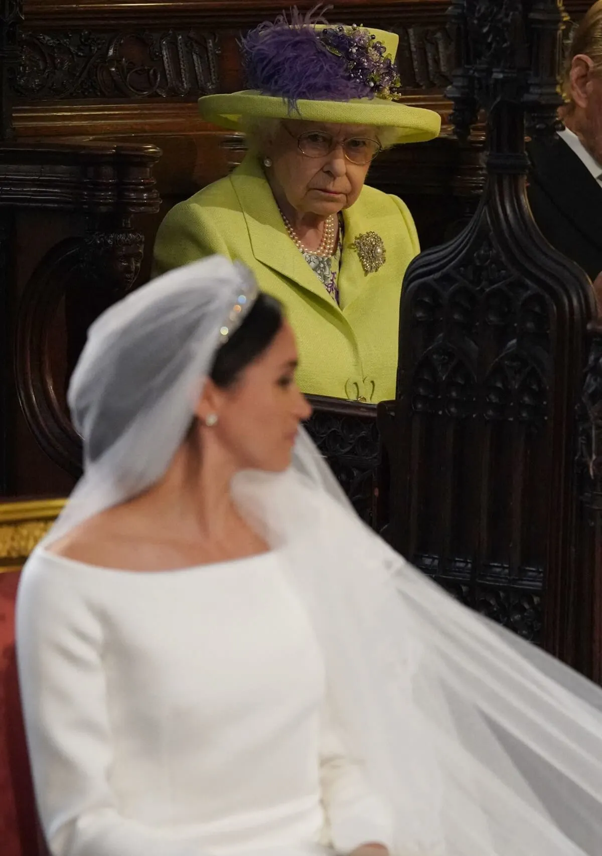 Queen Elizabeth II looking at Meghan Markle during the duchess's wedding ceremony to Prince Harry