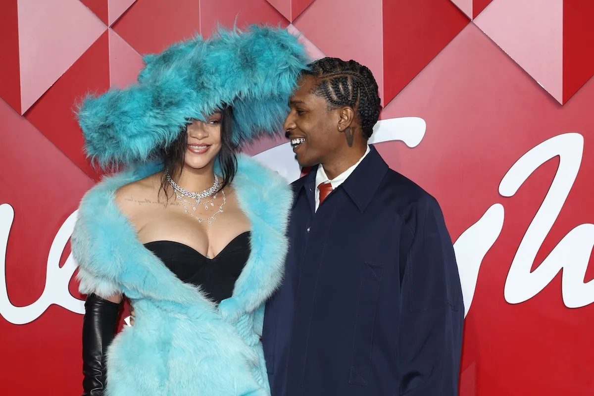 Wearing a fluffy blue dress, Rihanna poses with A$AP Rocky on the red carpet before The Fashion Awards 2024