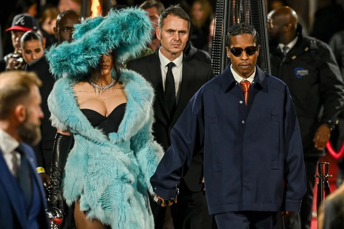 Wearing a fluffy blue dress, Rihanna poses with A$AP Rocky on the red carpet before The Fashion Awards 2024