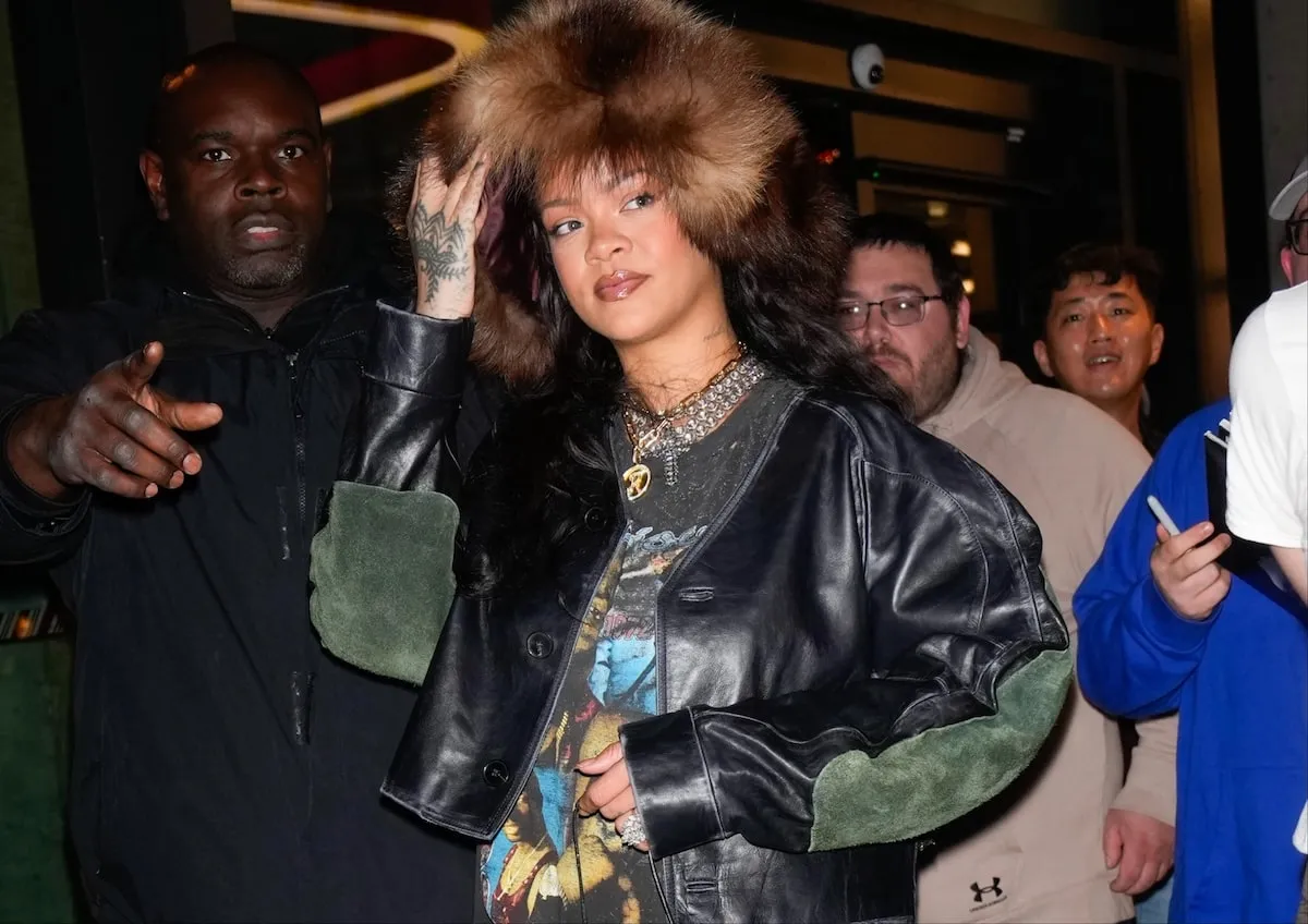 Wearing a huge fur hat, Rihanna looks at the paparazzi in NYC