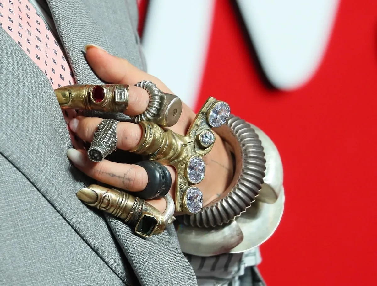 Singer Rita Ora's left hand, wearing several rings and cuffs in gold and silver