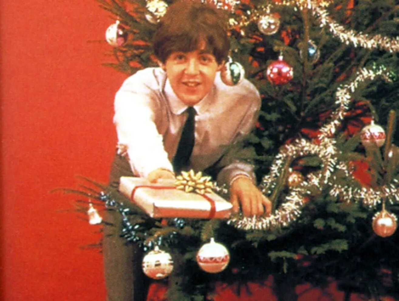 Paul McCartney with a Christmas tree