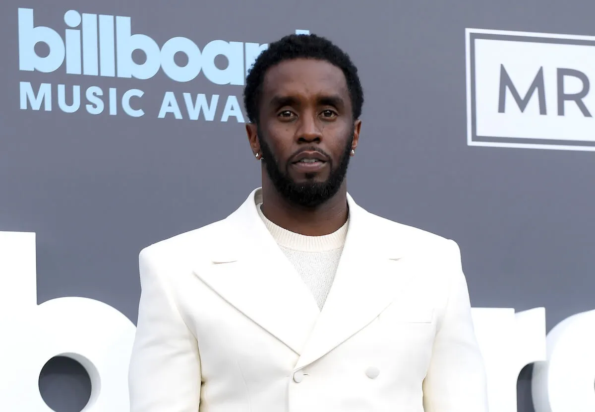 Sean 'Diddy' Combs wears a white double breasted suit.