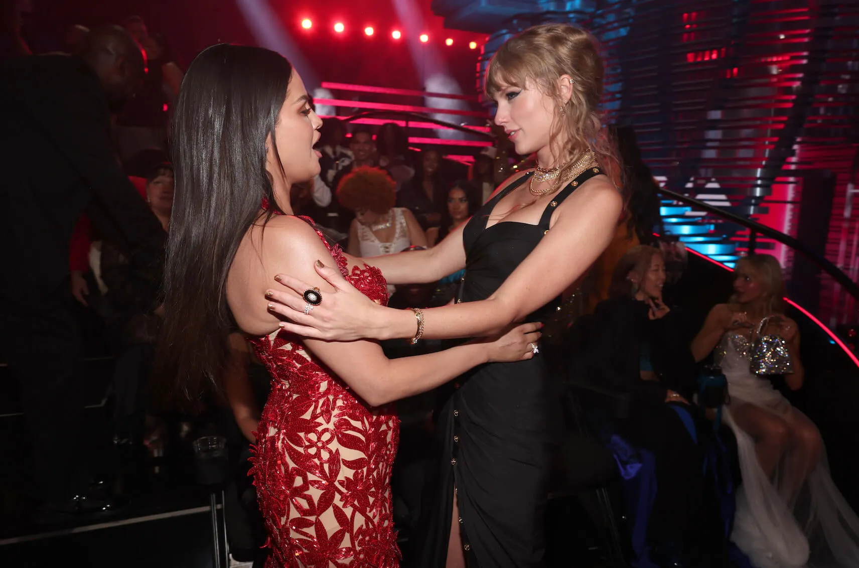 Selena Gomez and Taylor Swift looking at each other as they pull away from an embrace at the 2023 MTV Video Music Awards