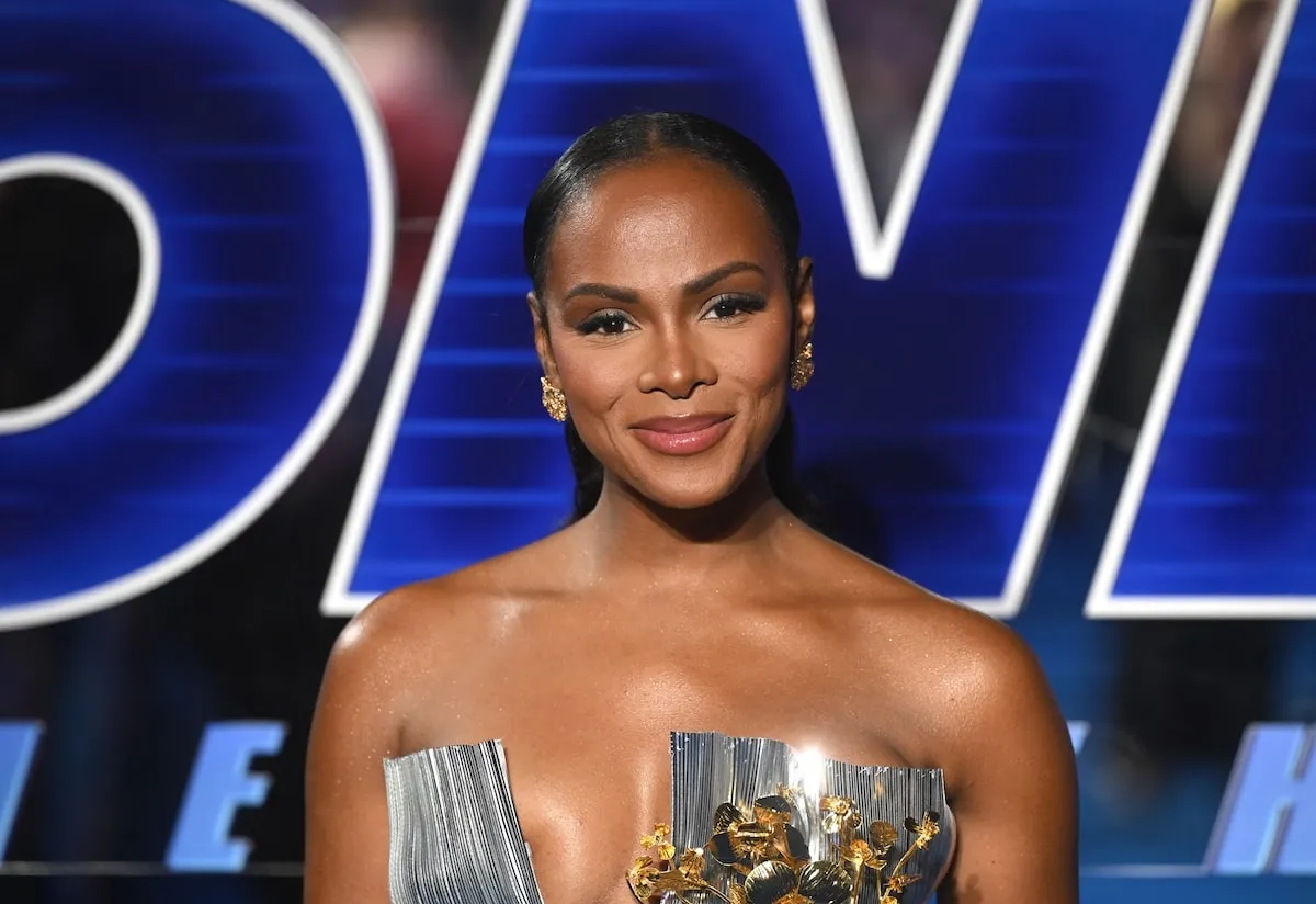 Wearing a silver gown, Tika Sumpter smiles on the red carpet at the London premiere of Sonic the Hedgehog 3