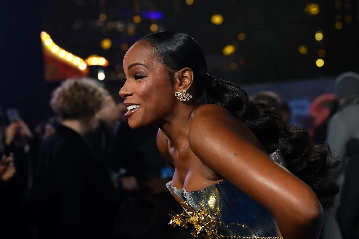 Wearing a silver gown, Tika Sumpter smiles on the red carpet at the London premiere of Sonic the Hedgehog 3