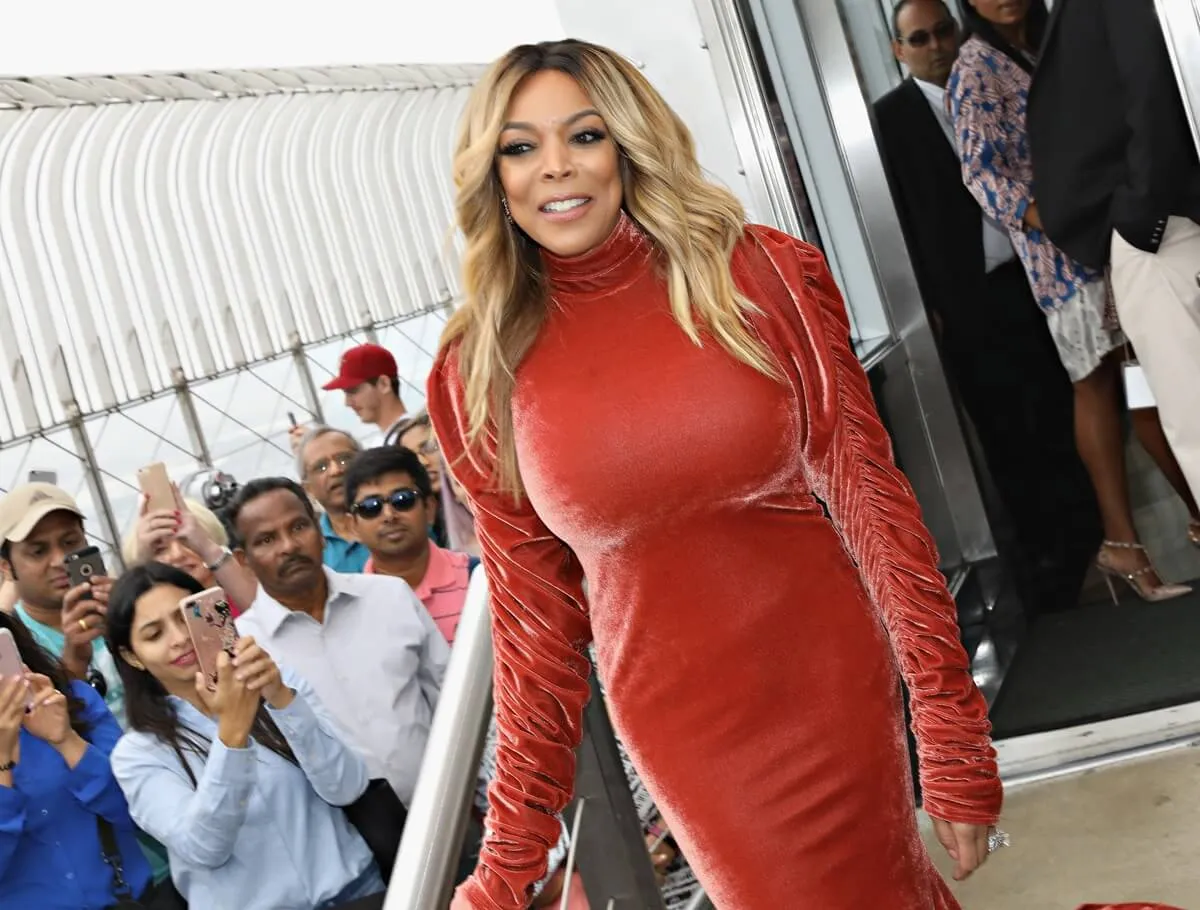 Wendy Williams posing in a red dress.