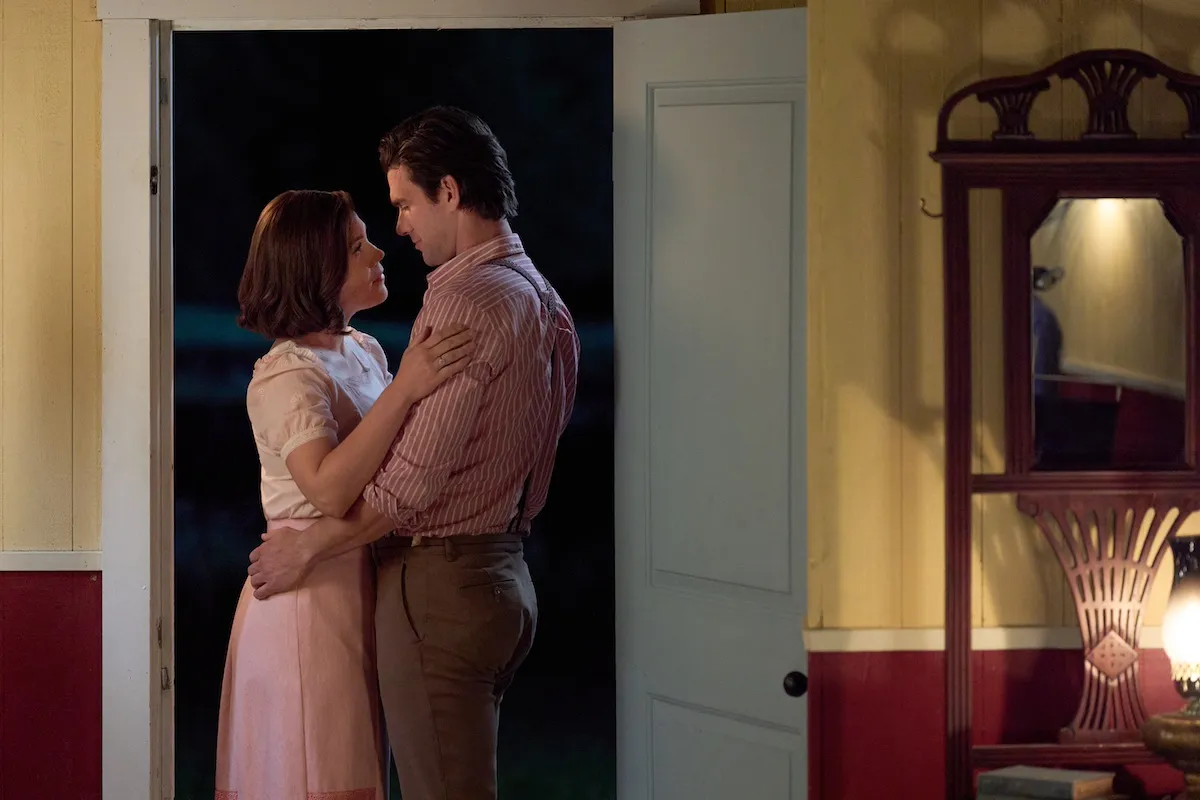 Elizabeth and Nathan embrace in a doorway in the 'When Calls the Heart' Season 12 premiere