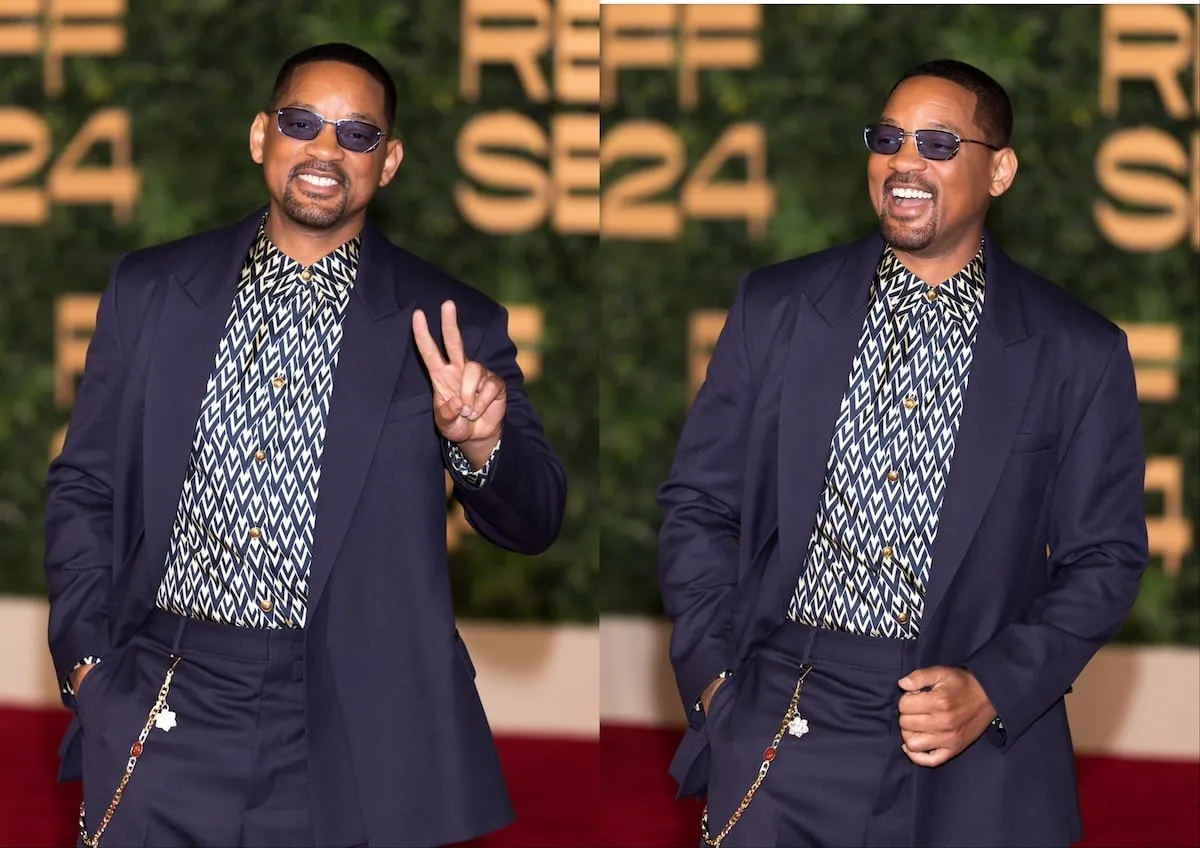 Wearing a navy suit and blue sunglasses, Will Smith takes photos on the red carpet at the Opening Ceremony of The Red Sea International Film Festival 2024