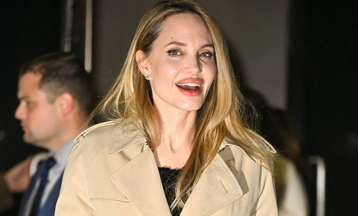 Angelina Jolie leaving 'Maria' screening in a brown trench coat and black shirt.