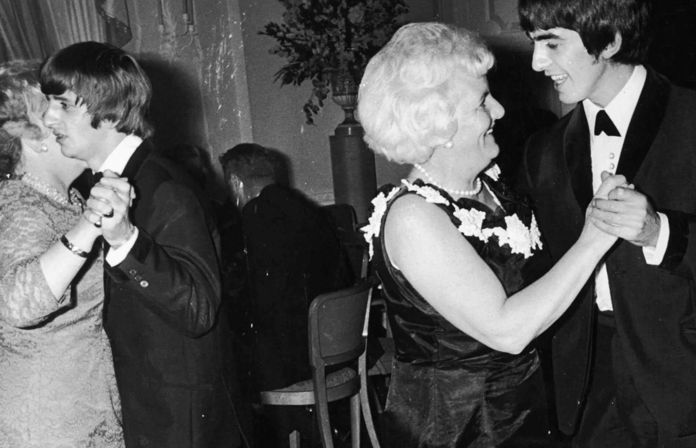 George Harrison dancing with a woman