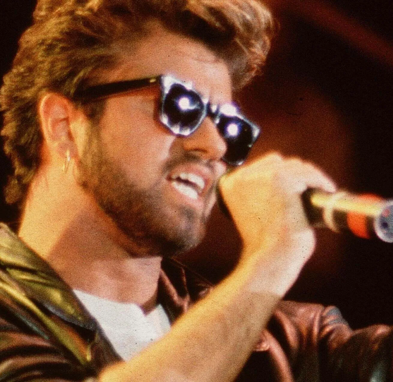 "Last Christmas" star George Michael with a microphone