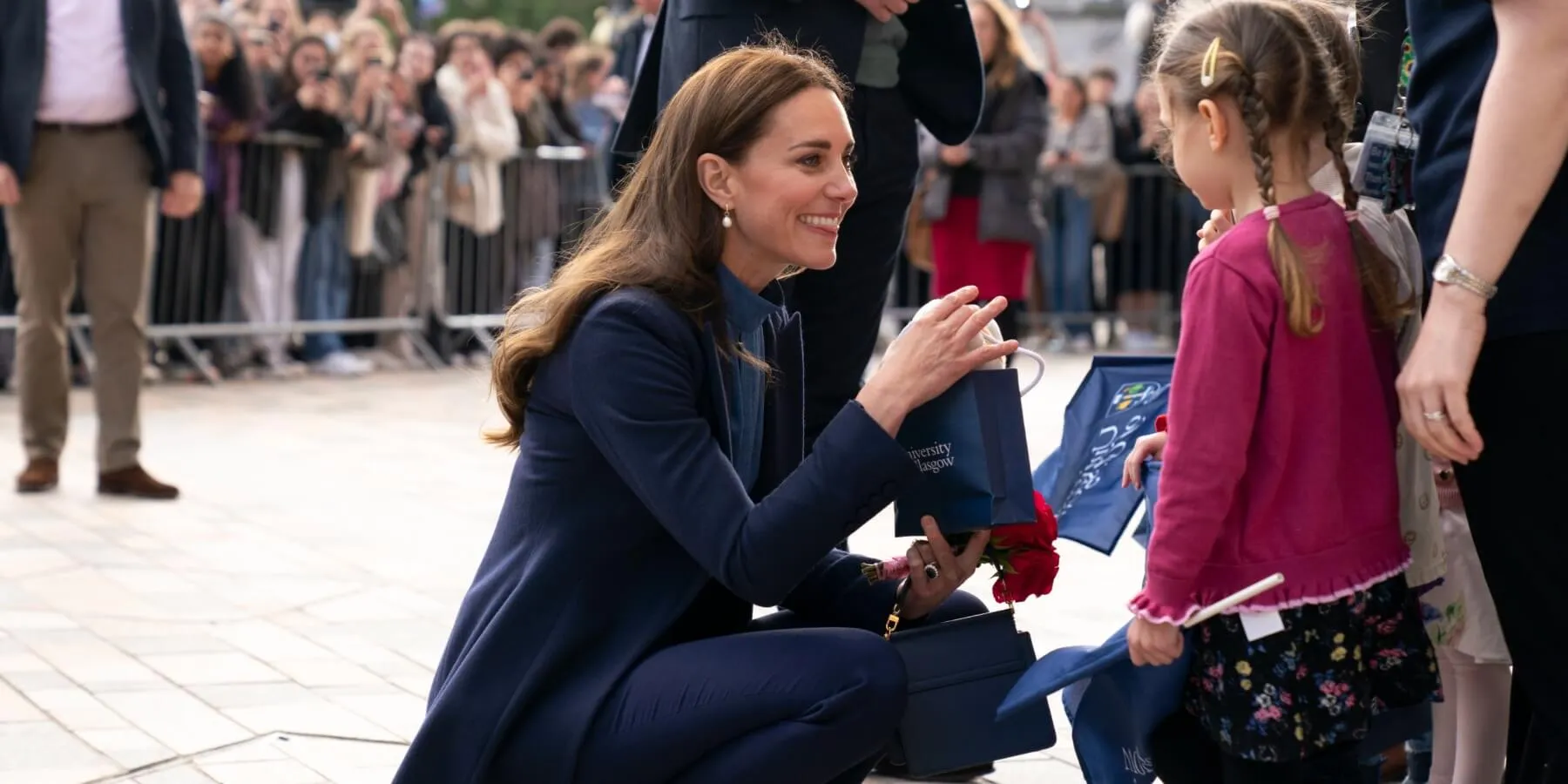 Kate Middleton accepts a gift from a young royal fan in 2022.