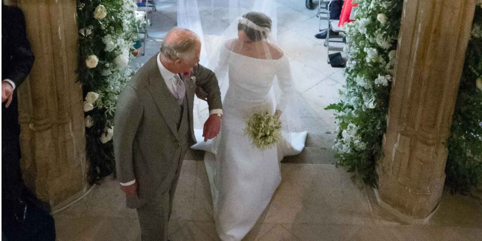 King Charles escorts Meghan Markle down the aisle at her wedding to Prince Harry.