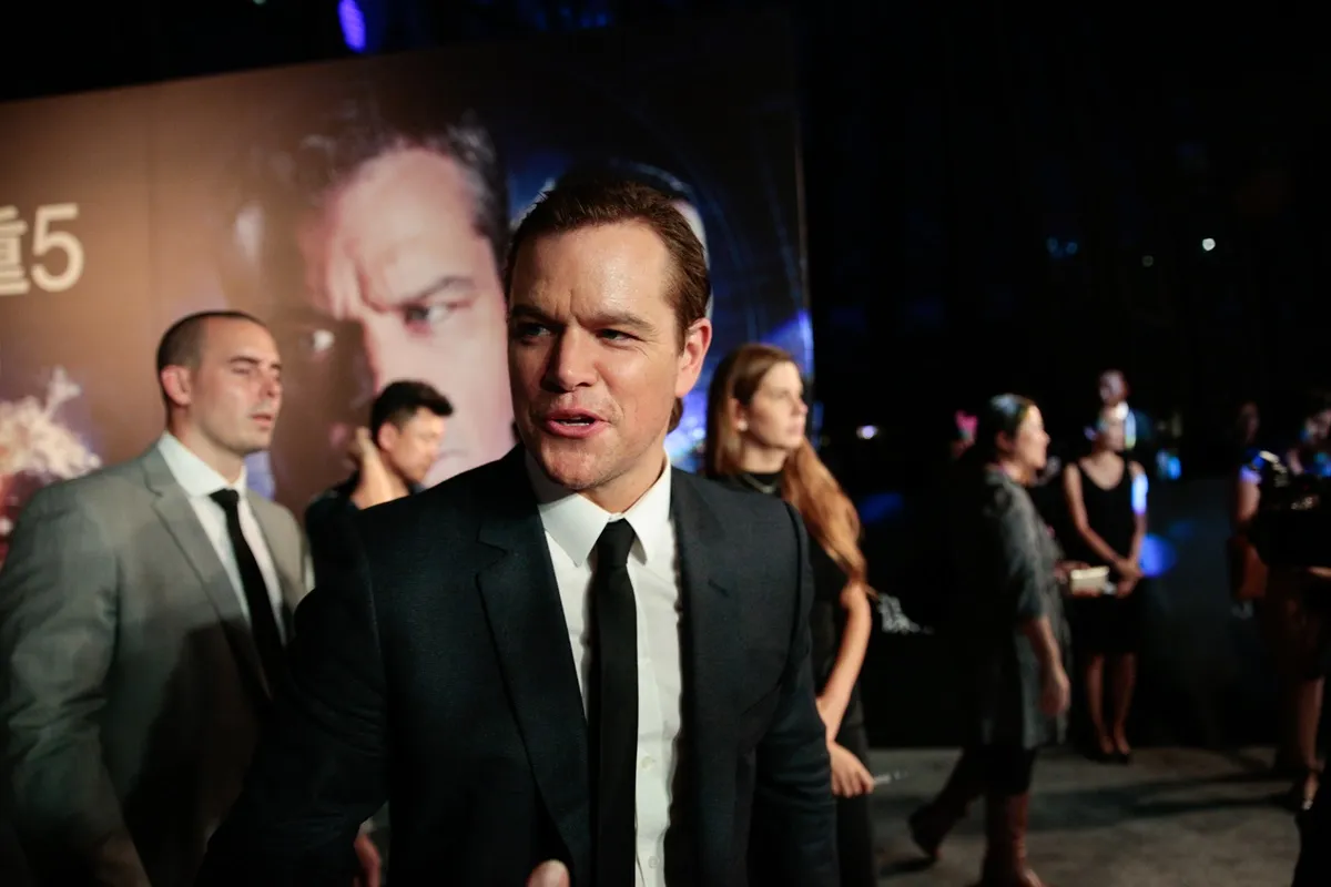 Matt Damon posing in a suit at the premiere of 'Jason Bourne'.