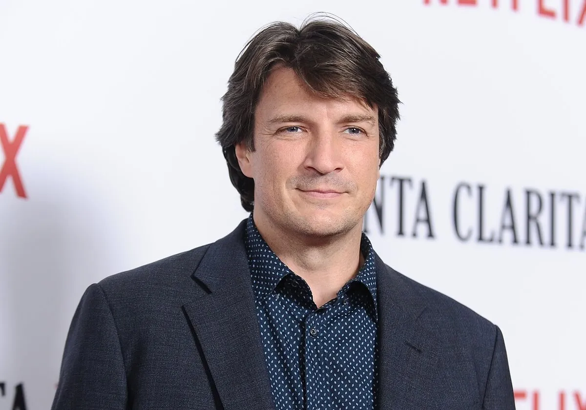 Nathan Fillion attends the premiere of "Santa Clarita Diet" in a blazer and collared shirt.