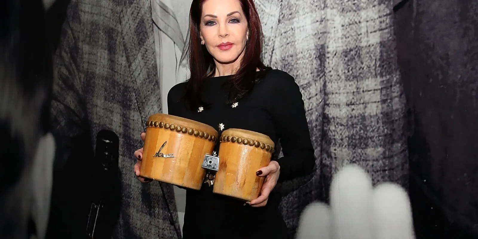 Priscilla Presley photographed with the bongos she gifted Elvis Presley during their first Christmas together in 1958.