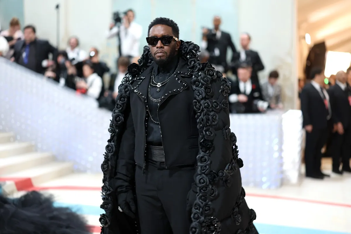 Sean Diddy Combs posing in a black outfit at the 2023 Met Gala.