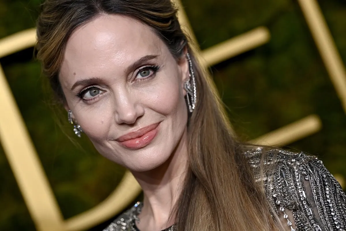 Angelina Jolie smirking at the 82nd Annual Golden Globe Awards.