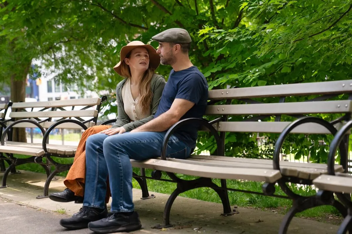 Man and woman wearing hats and sitting on a park bench in TLC's 'Big City, Big Family'