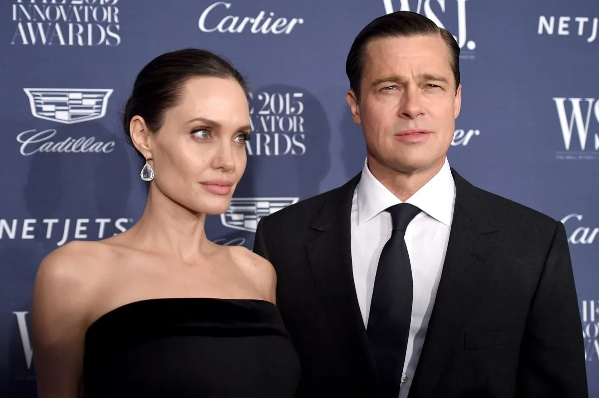 Brad Pitt and Angelina Jolie posing at the WSJ. Magazine 2015 Innovator Awards.