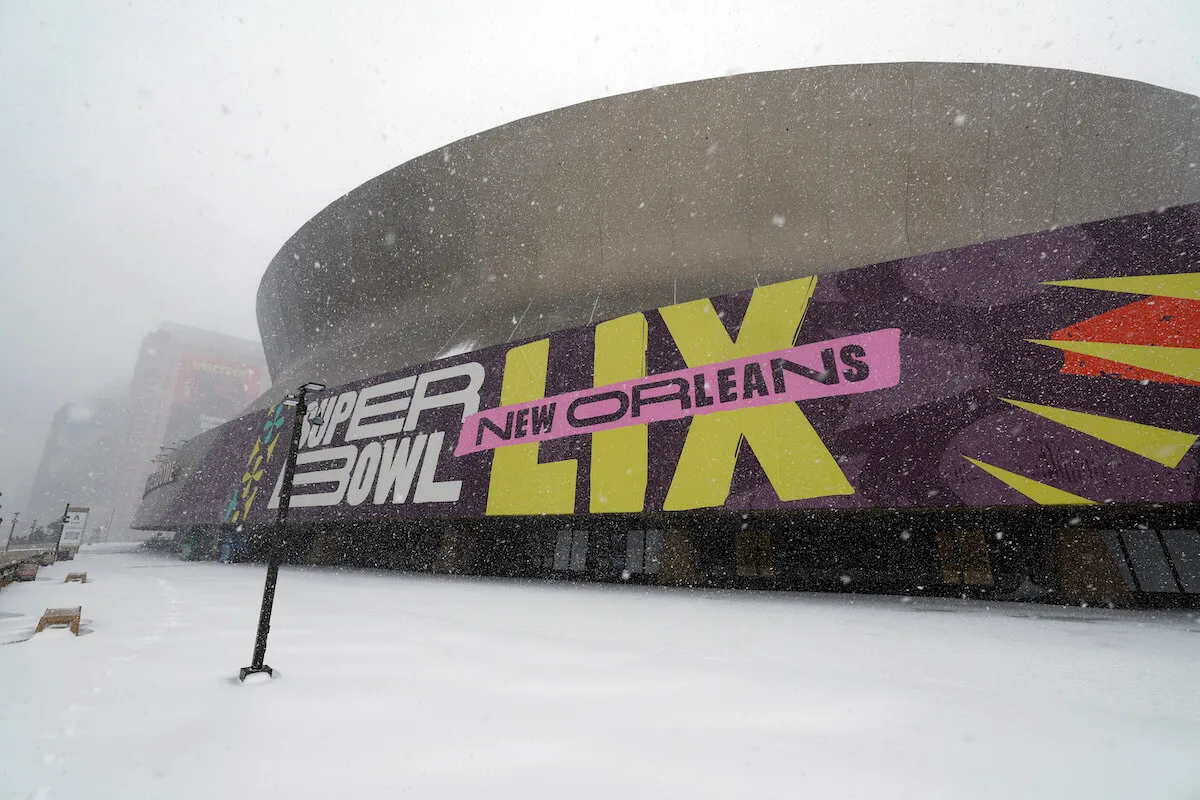 The exterior of Caesars Superdome, the location of Super Bowl LIX, blanketed in snow.