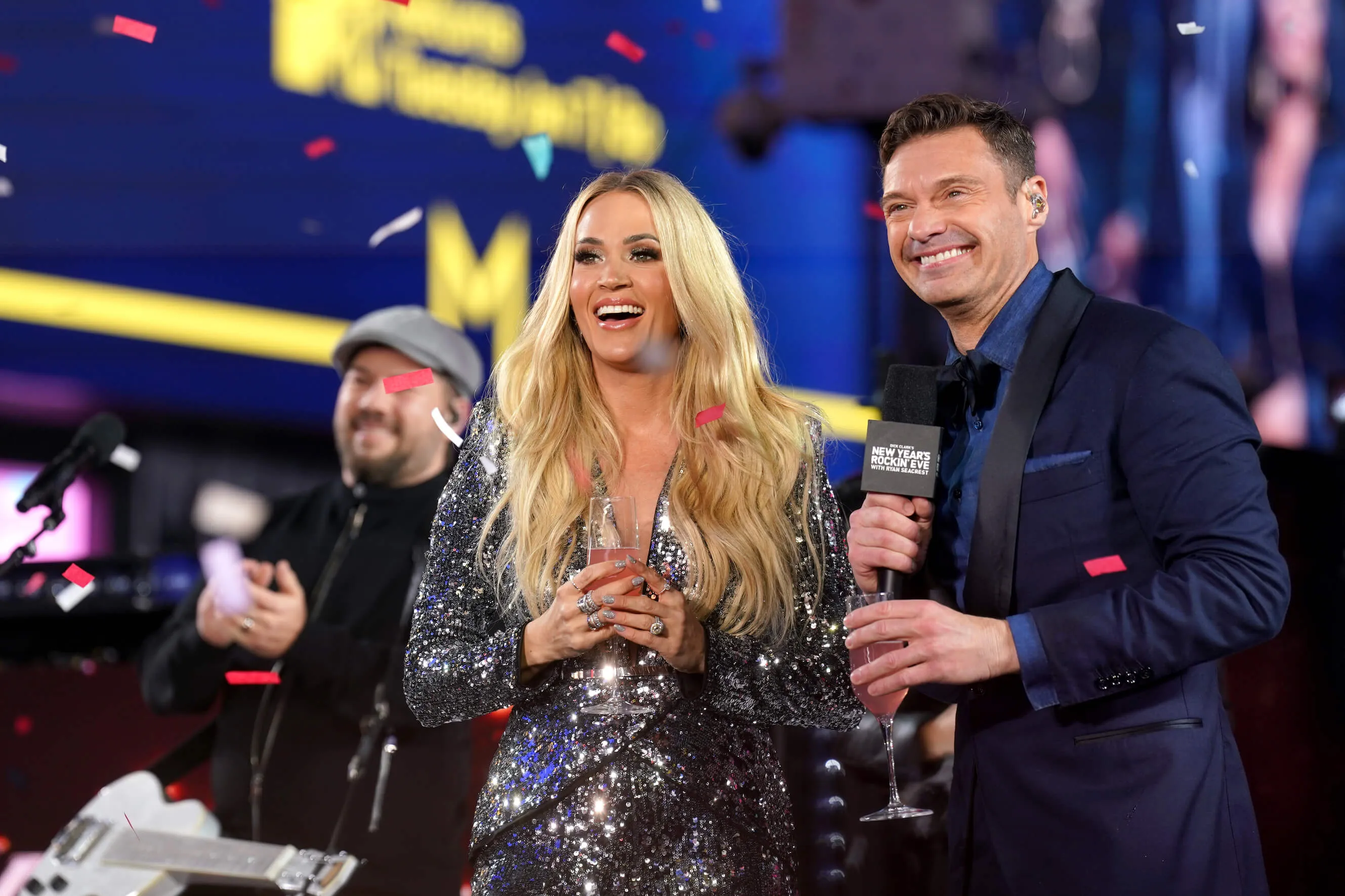 Carrie Underwood and Ryan Seacrest smiling next to each other at 'Dick Clark's New Year's Rockin' Eve with Ryan Seacrest 2025'