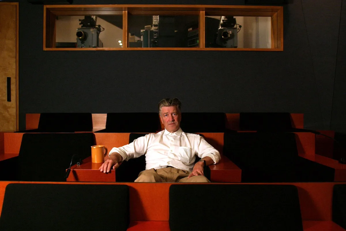 David Lynch sitting alone in a screening room