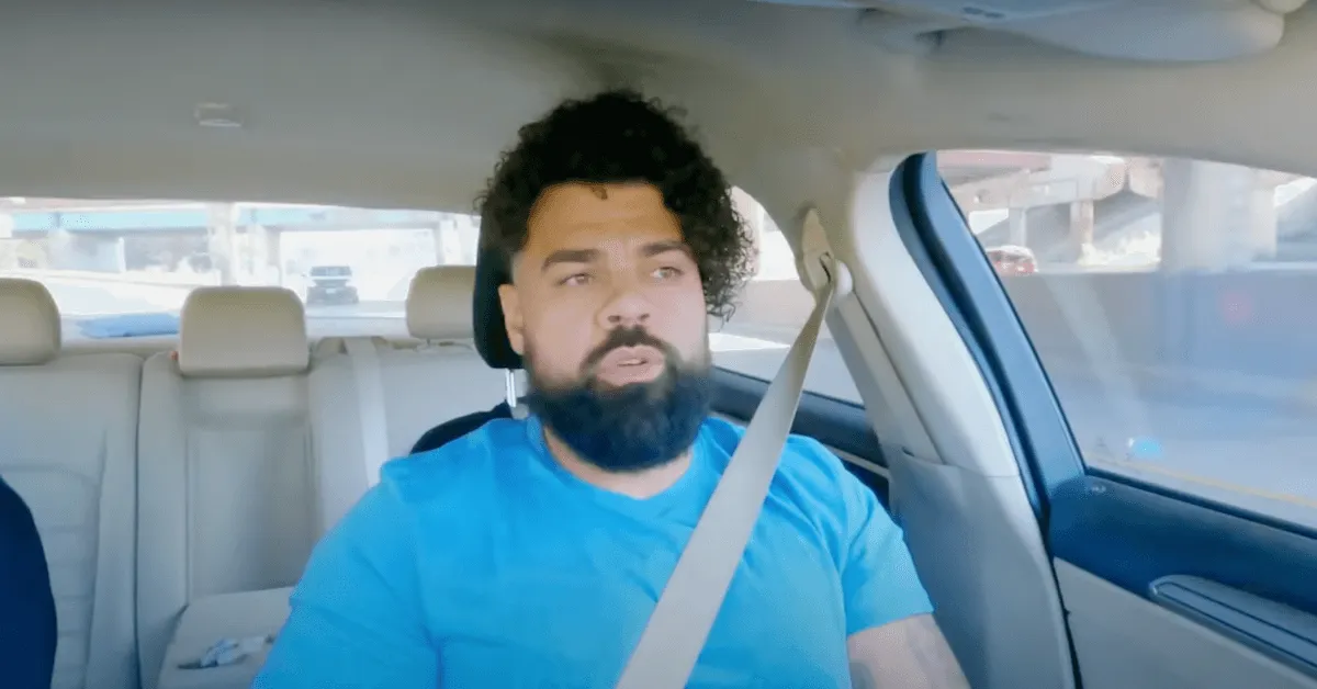 David from 'Married at First Sight' Season 18 wearing a blue T-shirt and driving a car