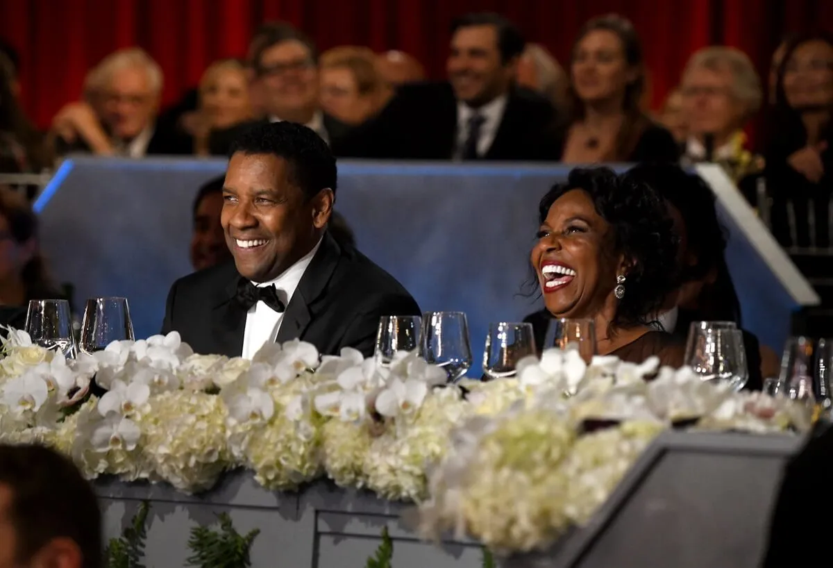 Pauletta Washington laughing next to husband Denzel Washington at the 47th AFI Life Achievement Award.