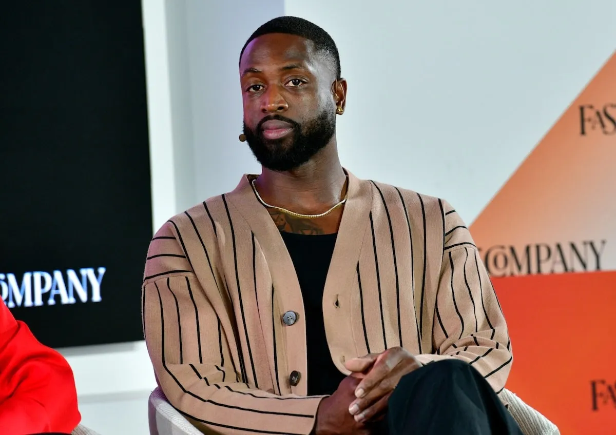 Wearing a tan cardigan, Dwyane Wade speaks at the Fast Company Innovation Festival at Convene on September 21, 2023