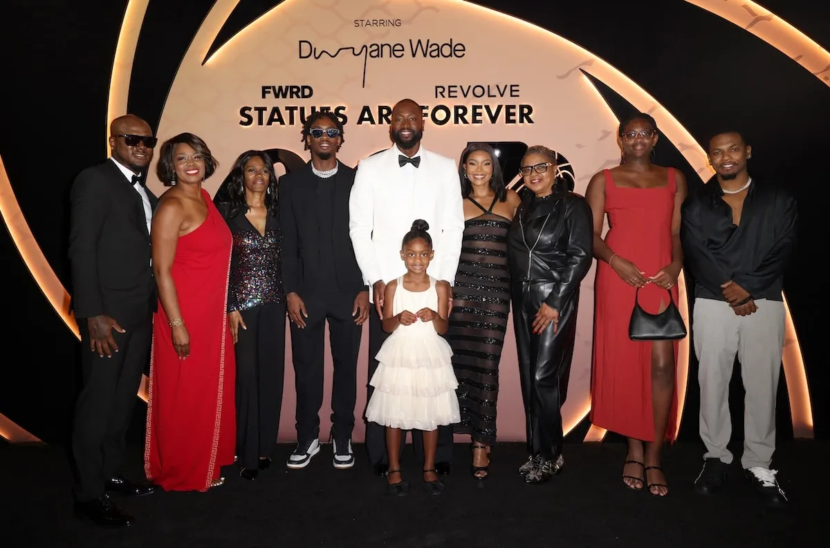 Dwyane Wade stands with his wife and kids at a black tie event in 2024