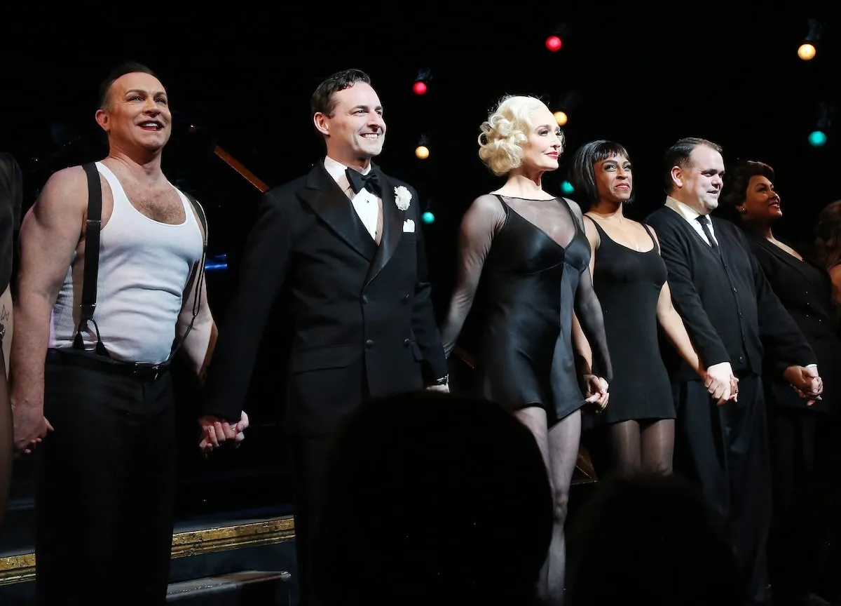 Smiling broadly, Erika Jayne stands onstage as Roxie Hart during the curtain call as she rejoins "Chicago The Musical"