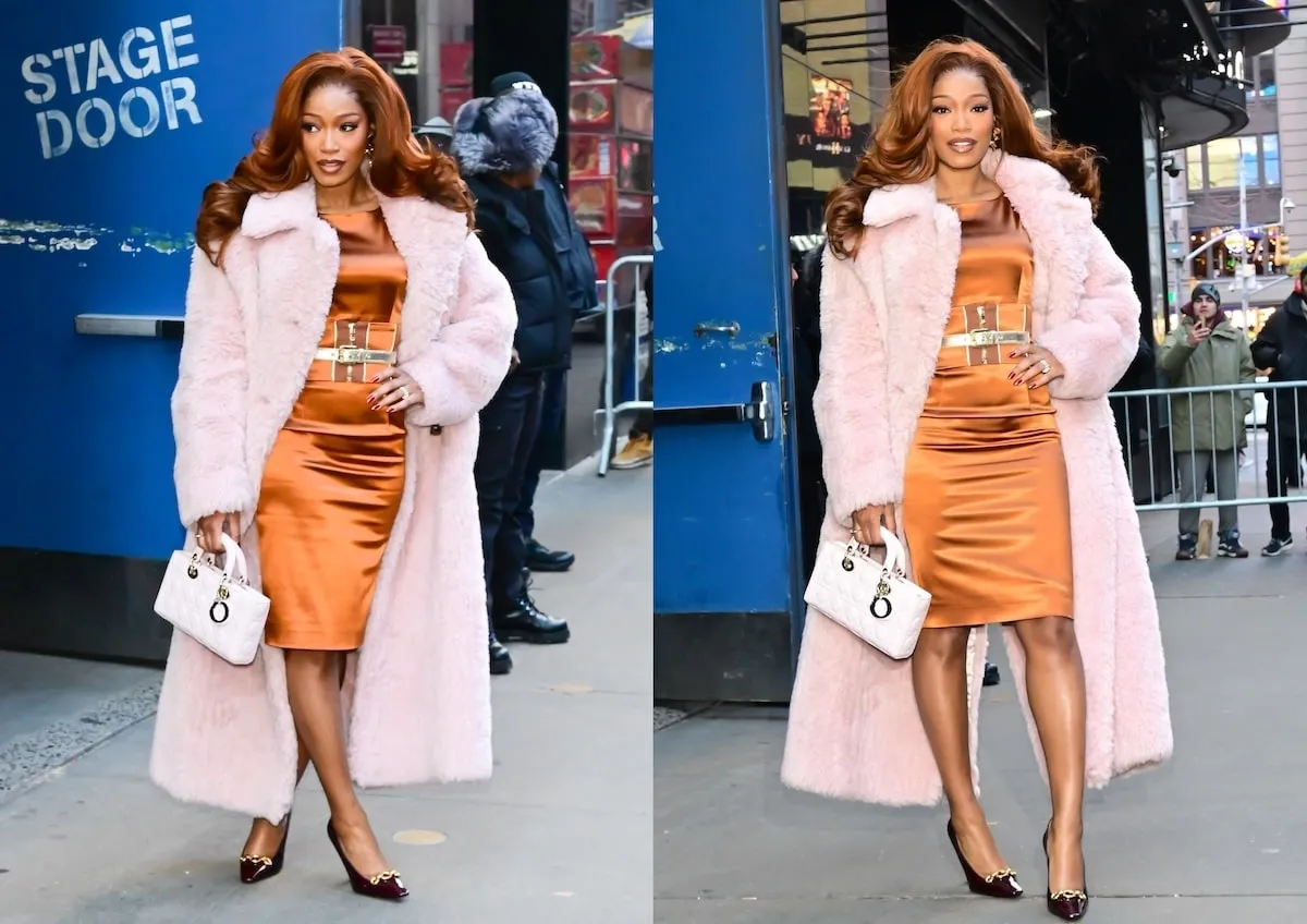 Wearing a pink furry coat, Keke Palmer smiles at paparazzi while exiting GMA Studios in NYC