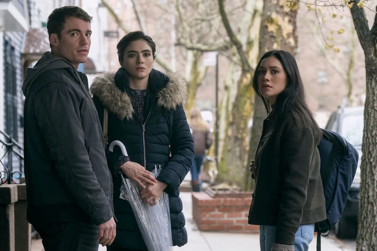 Gabriel Basso, Arienne Mandi, and Luciane Buchanan stand on the street in 'The Night Agent' Season 2