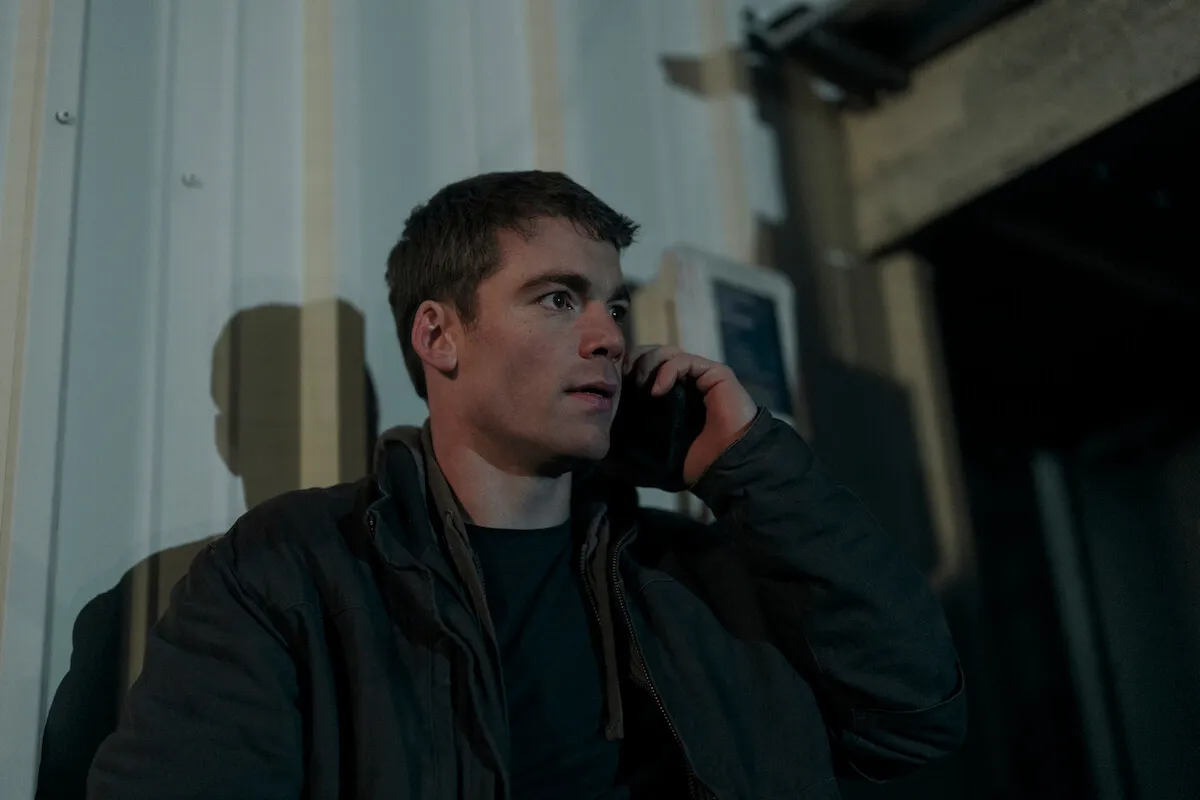 Gabriel Basso holds a phone up to his ear in 'The Night Agent' Season 2