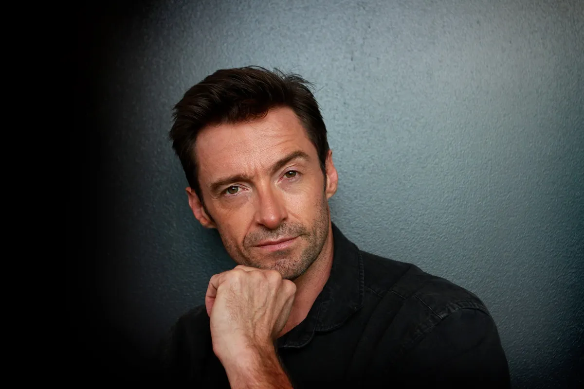 Hugh Jackman posing in a black shirt during a photocall for 'Real Steel'.