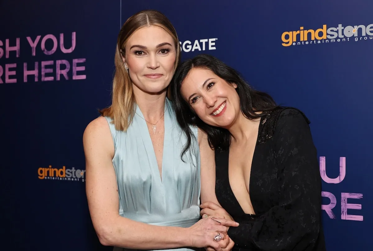 2000s stars Julia Stiles and Vanessa Carlton hold each other and smiles at a screening of their movie, Wish You Were Here, in 2025