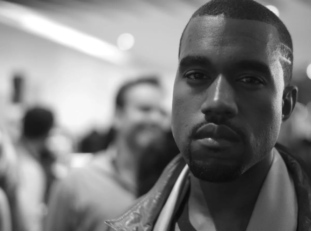 A black and white picture of Kanye West looking at the camera.