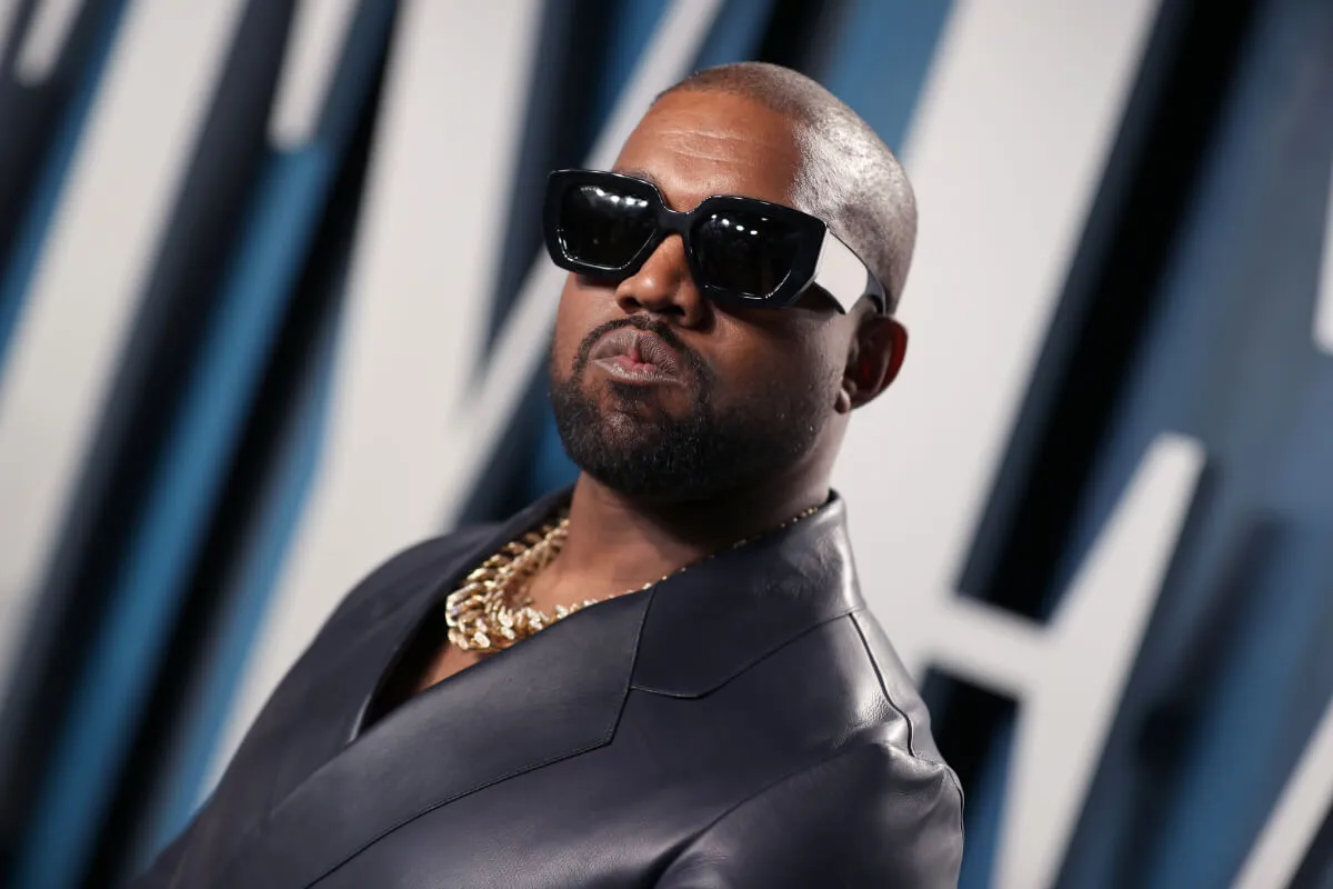 Kanye West wears a blazer and sunglasses