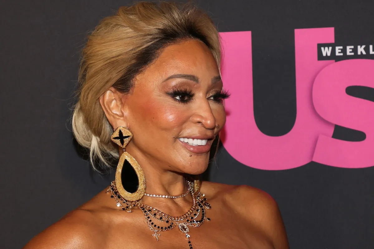 Smiling Karen Huger of 'RHOP' wearing large earrings