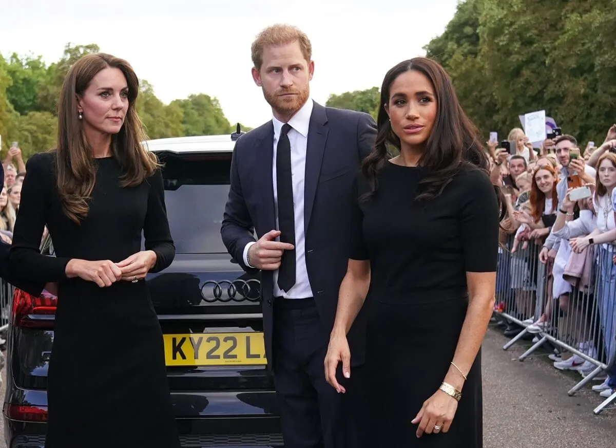 Kate Middleton, Prince Harry, and Meghan Markle meet members of the public on the Long Walk at Windsor Castle