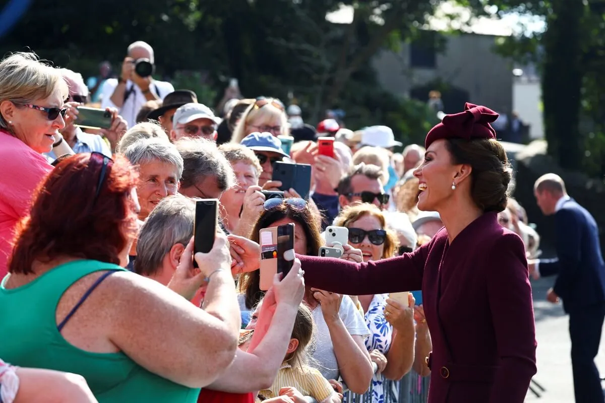 Kate Middleton meets with well-wishers as she visits St. David's Cathedral on the anniversary of Queen Elizabeth's death