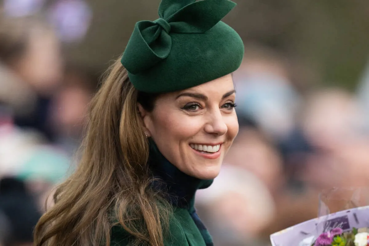 Kate Middleton, who is reportedly rethinking her wardrobe for 2025, looks on and smiles wearing green.