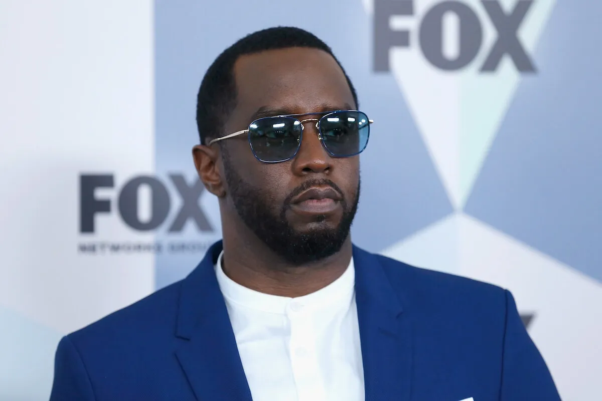 Sean 'Diddy' Combs wears a blue suit jacket and sunglasses.