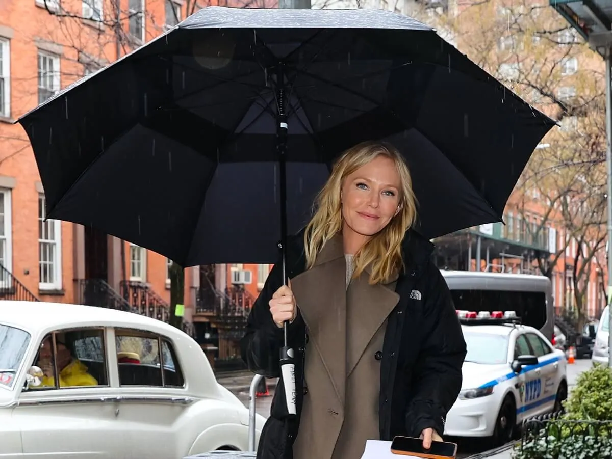 Kelli Giddish on the set of 'SVU' holding an umbrella.