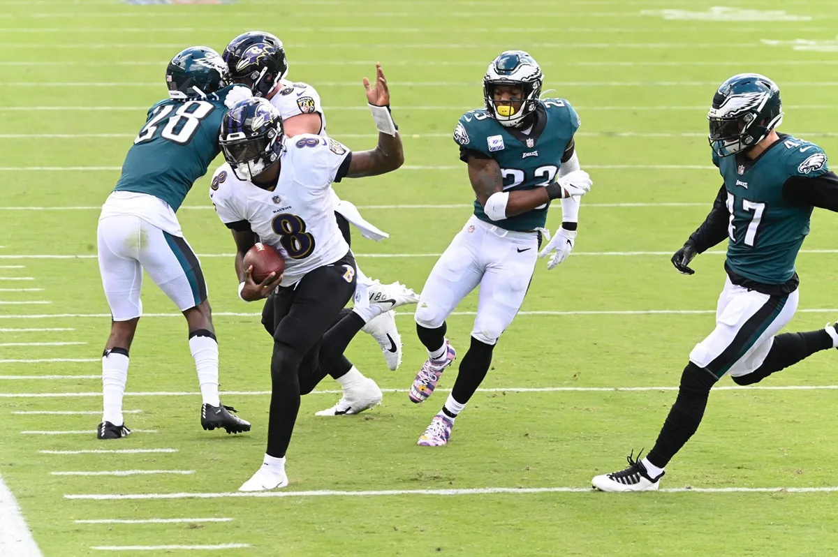 Baltimore Ravens quarterback Lamar Jackson (8) runs for a first down in the first quarter against the Philadelphia Eagles on Sunday, Oct. 18, 2020 at Lincoln Financial Field in Philadelphia, Pennsylvania