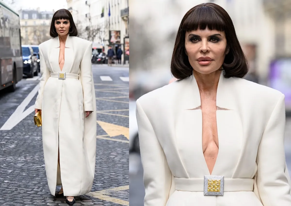 Wearing a white suit and coat, Lisa Rinna poses on a Paris street before the Stéphane Rolland show during Paris Fashion Week